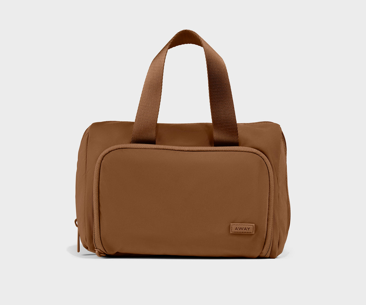 Featherlight Daily Cosmetic Case in Amaro Brown by Away — brand photography